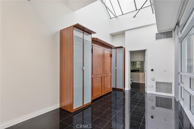 bathroom with a towering ceiling