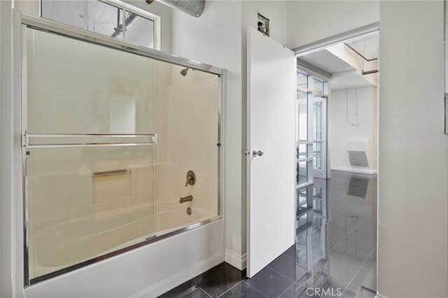 bathroom featuring shower / bath combination with glass door and tile patterned flooring