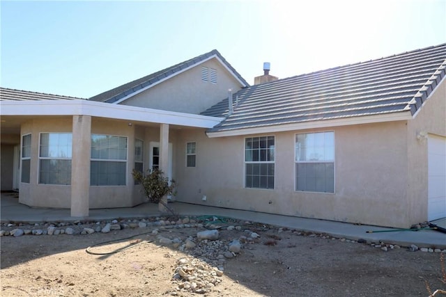 back of house featuring a garage