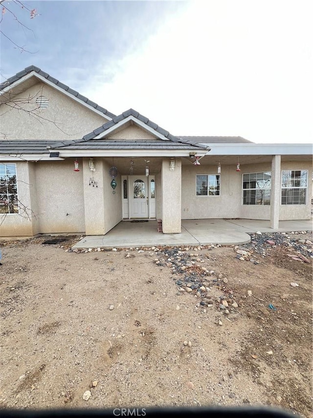 back of property with a patio area