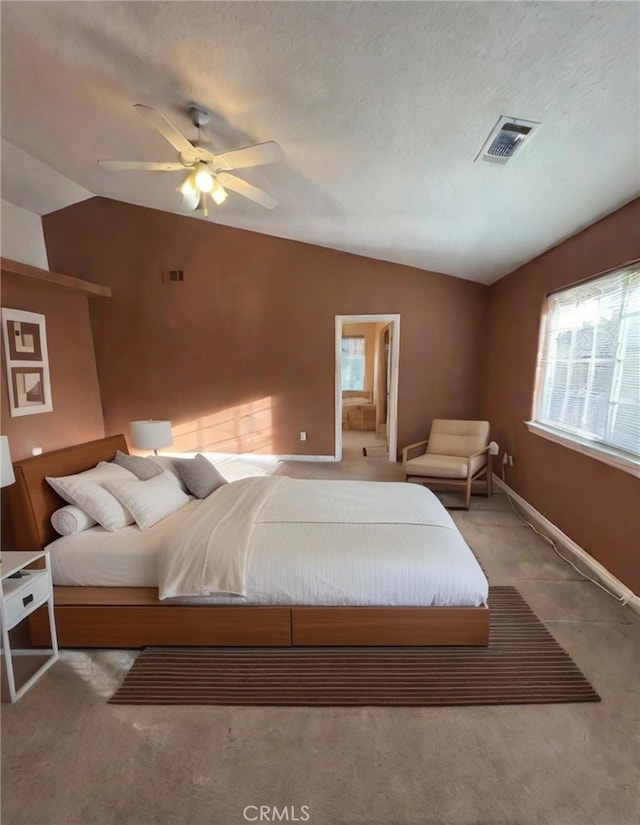 carpeted bedroom with ceiling fan, a textured ceiling, and lofted ceiling