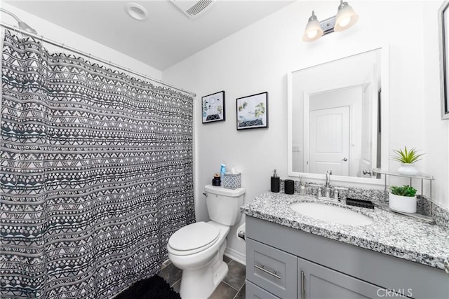 bathroom with toilet, tile patterned flooring, and vanity