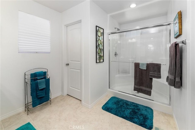 bathroom featuring walk in shower and tile patterned flooring