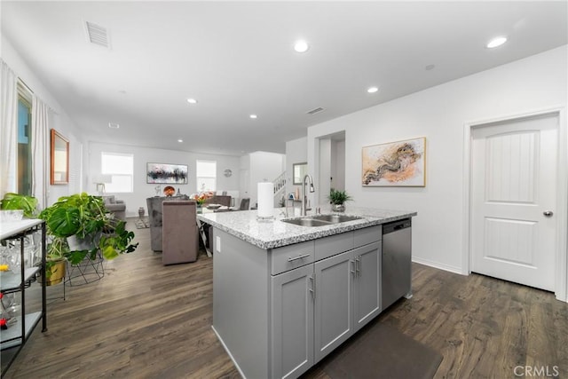 kitchen with sink, an island with sink, dishwasher, and gray cabinetry