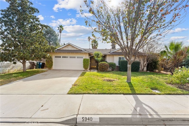 single story home featuring a garage and a front yard