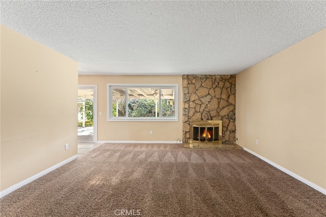 unfurnished living room featuring a fireplace, a textured ceiling, and carpet flooring