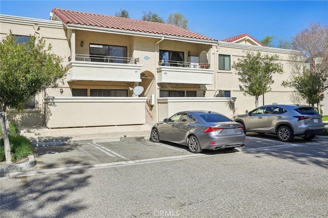 18808 Mandan St Unit 312, Canyon Country, CA 91351 - view of building exterior with uncovered parking and fence