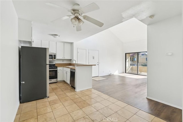 18808 Mandan St Unit 312, Canyon Country, CA 91351 - kitchen with open floor plan, a ceiling fan, a peninsula, white cabinetry, and stainless steel appliances
