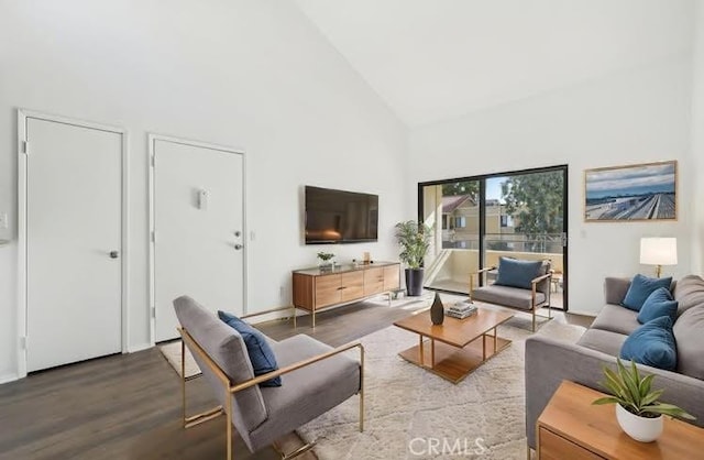 18808 Mandan St Unit 312, Canyon Country, CA 91351 - living room featuring high vaulted ceiling, baseboards, and wood finished floors