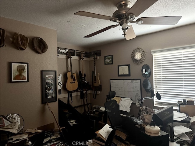 misc room with ceiling fan and a textured ceiling