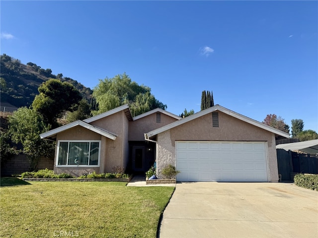 ranch-style house featuring a front yard and a garage