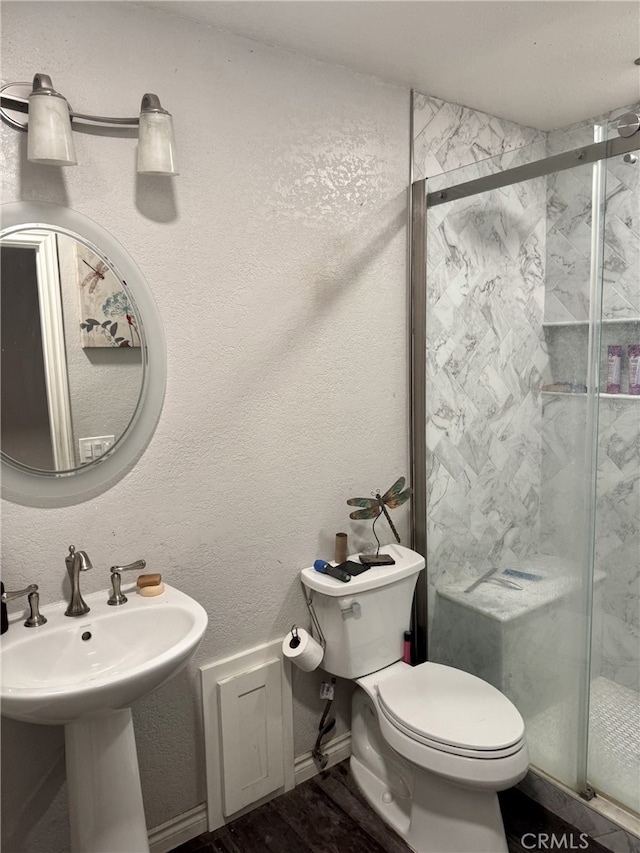 bathroom featuring sink, toilet, and walk in shower