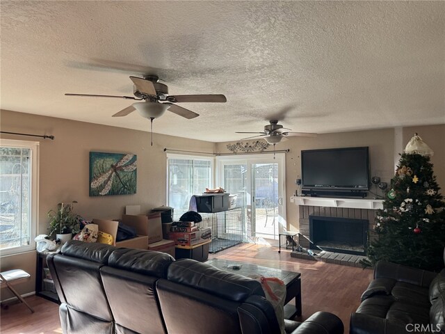 living room with plenty of natural light, a fireplace, and hardwood / wood-style flooring