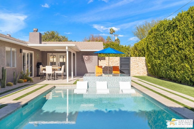 view of pool featuring french doors and a patio area