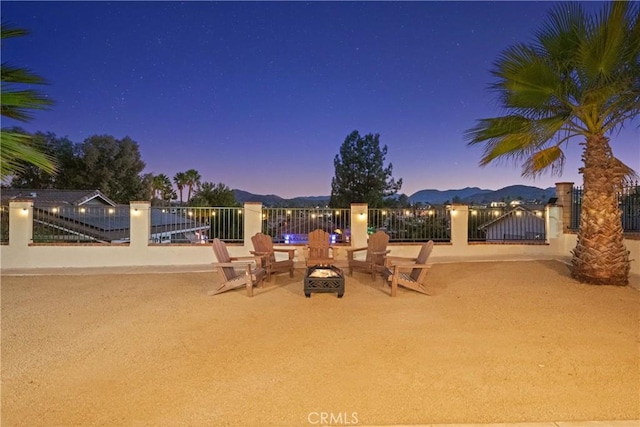 exterior space with a fire pit, fence, and a gate