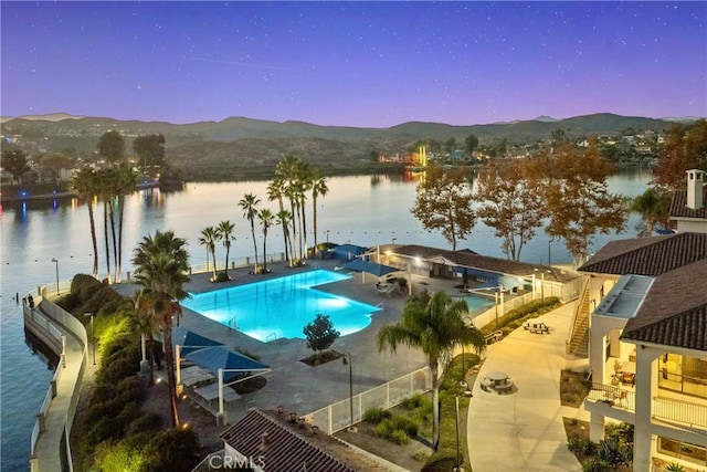 pool featuring a patio and a water and mountain view