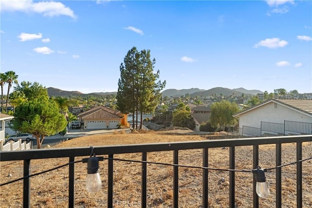 view of yard with fence and a mountain view