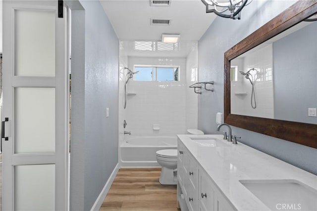 full bath with visible vents, a sink, toilet, and wood finished floors