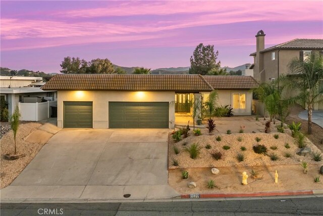 view of front of property featuring a mountain view and a garage