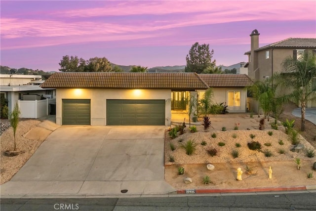 view of front of property with a garage and a mountain view