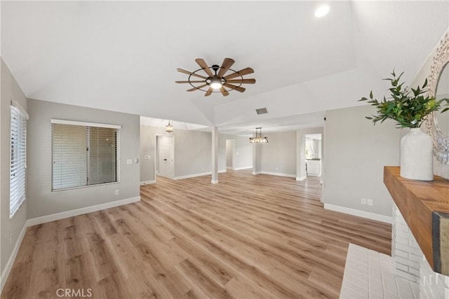 unfurnished living room featuring ceiling fan, lofted ceiling, light wood-style flooring, and baseboards