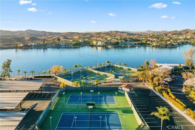 drone / aerial view featuring a water and mountain view