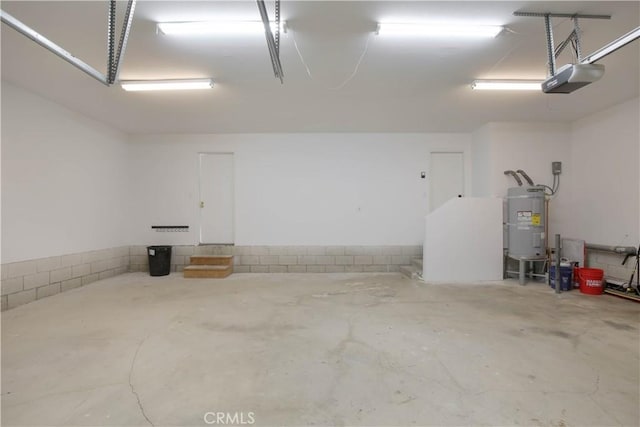 garage with secured water heater and a garage door opener