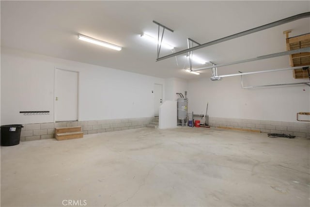 garage featuring water heater and a garage door opener