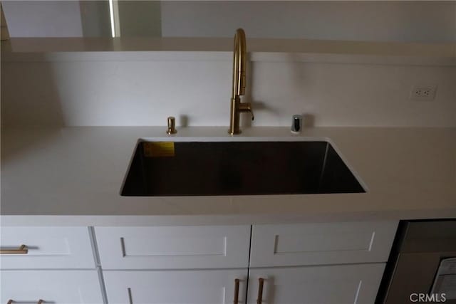 room details with sink and white cabinetry