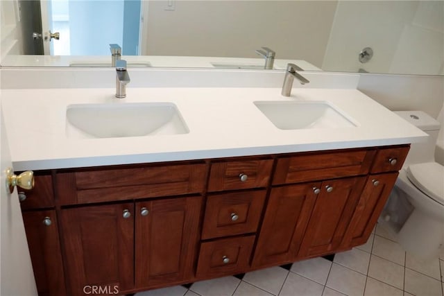 bathroom with toilet, tile patterned floors, and vanity