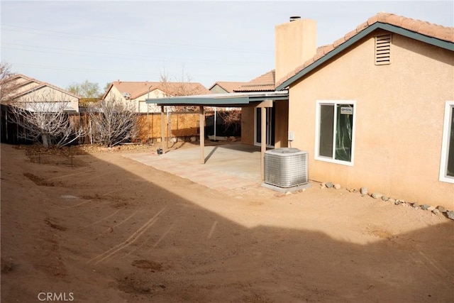 back of property with a patio area and central air condition unit