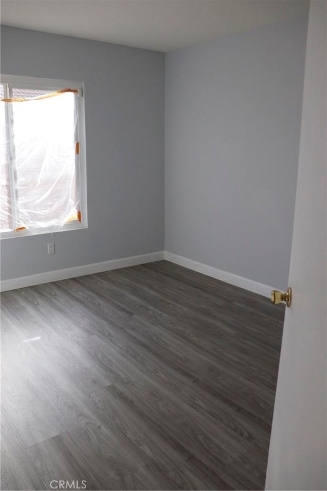 spare room with dark hardwood / wood-style floors