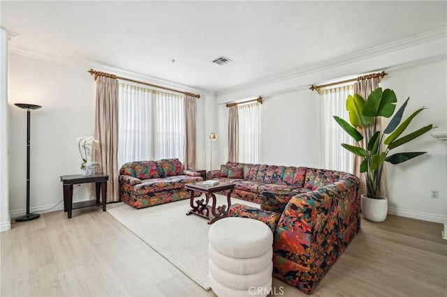 living room with crown molding and light wood-type flooring