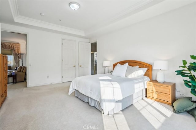 bedroom featuring light carpet, ornamental molding, and a raised ceiling