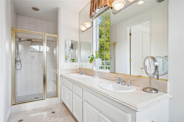 bathroom featuring a shower with shower door, tile patterned floors, and vanity