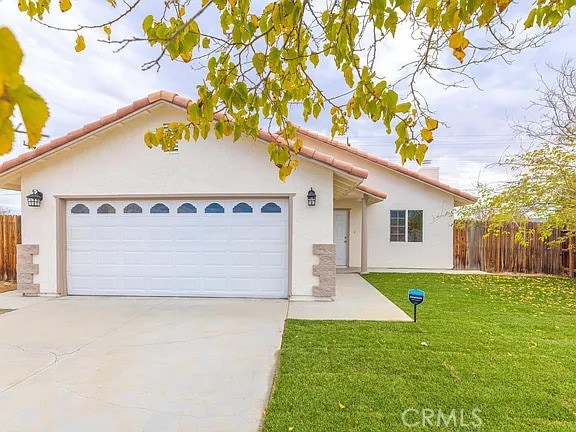 view of front facade with a front yard and a garage