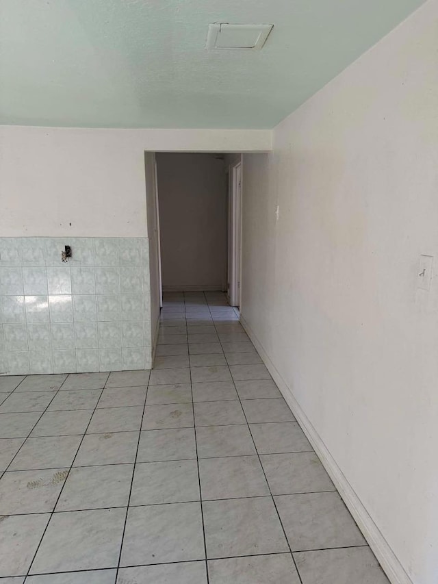 hall featuring light tile patterned floors