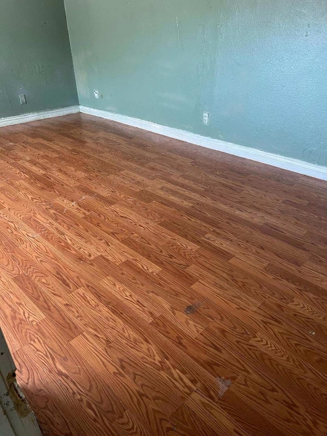 empty room with hardwood / wood-style floors