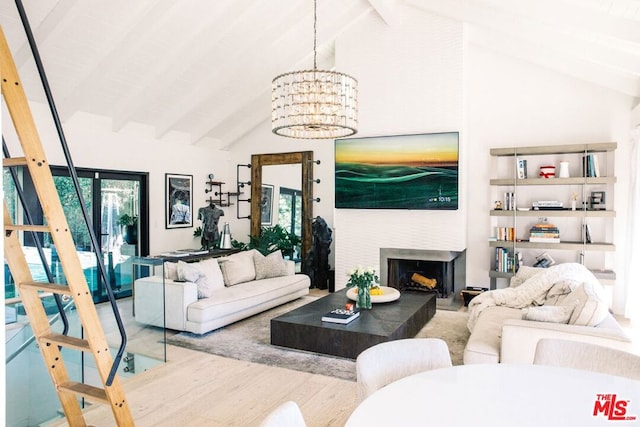 living room featuring high vaulted ceiling, beamed ceiling, an inviting chandelier, and hardwood / wood-style flooring