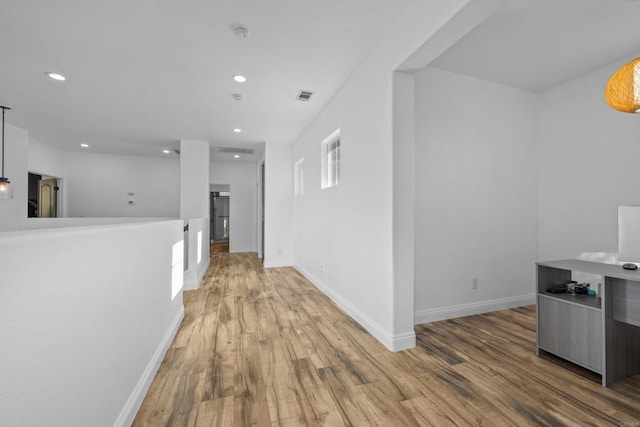 corridor featuring hardwood / wood-style floors