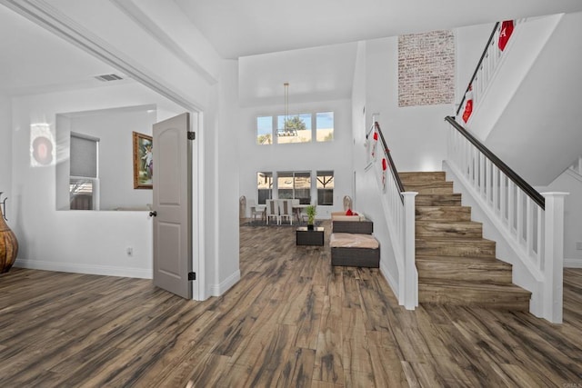 entryway featuring dark hardwood / wood-style flooring and a high ceiling