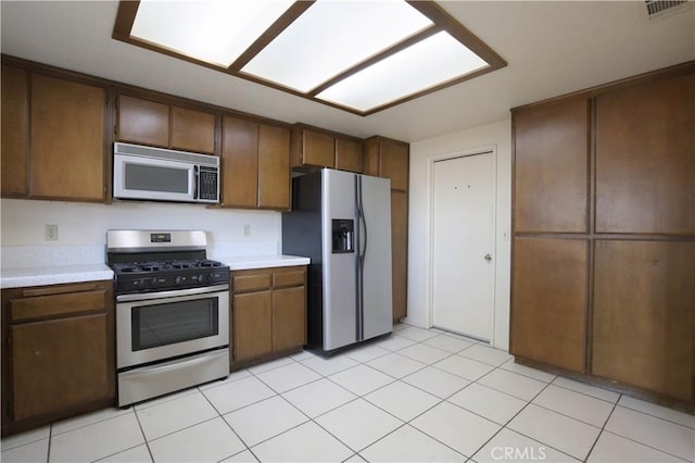 kitchen featuring light tile patterned flooring and stainless steel appliances