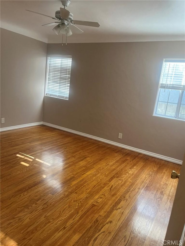 empty room with ceiling fan and wood-type flooring