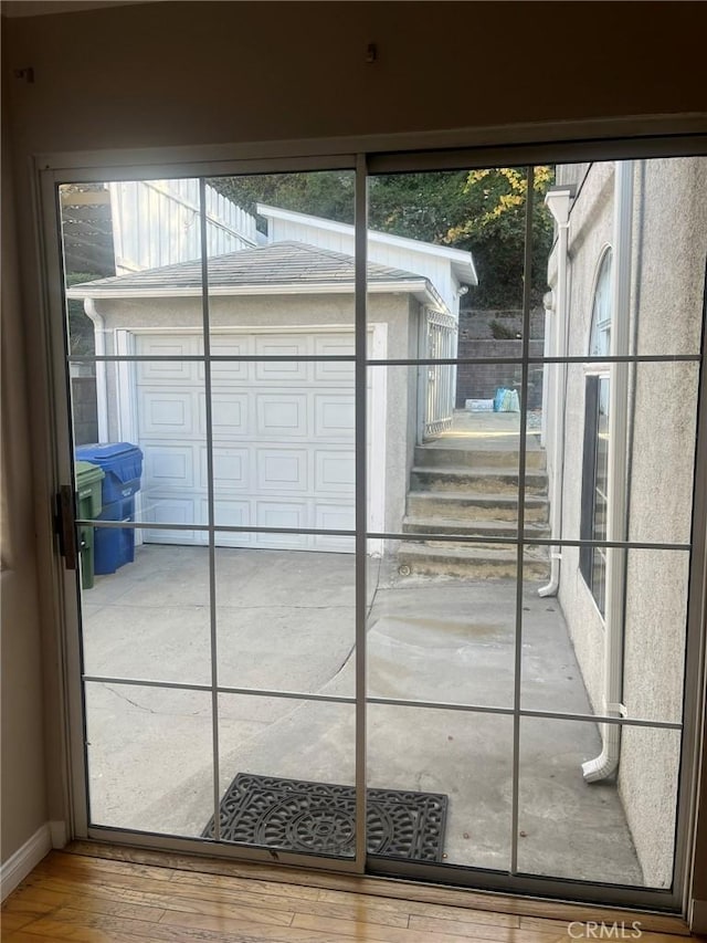 doorway with hardwood / wood-style floors