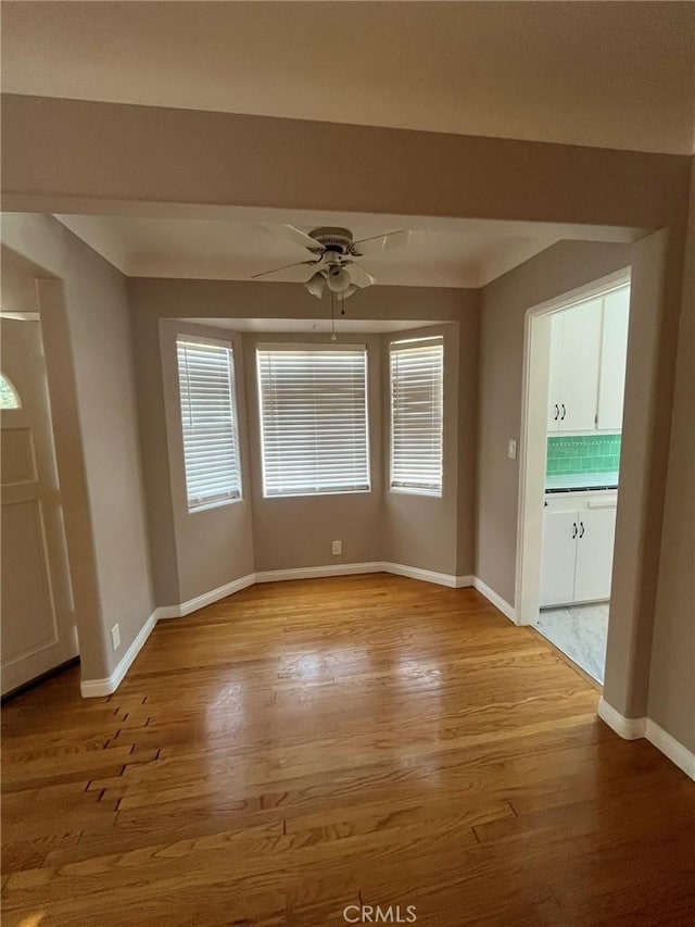 interior space with light wood-type flooring and ceiling fan