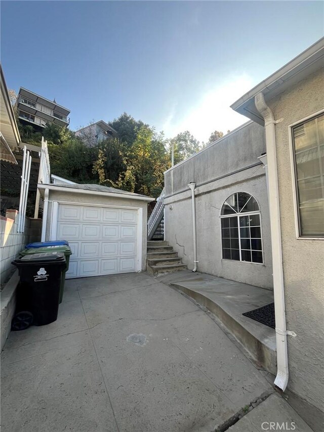 view of side of home with a garage and an outdoor structure