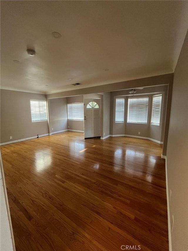 unfurnished living room featuring wood-type flooring