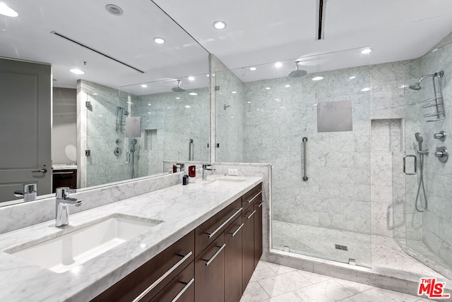 bathroom with walk in shower and vanity