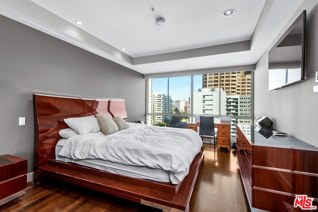 bedroom with dark hardwood / wood-style flooring