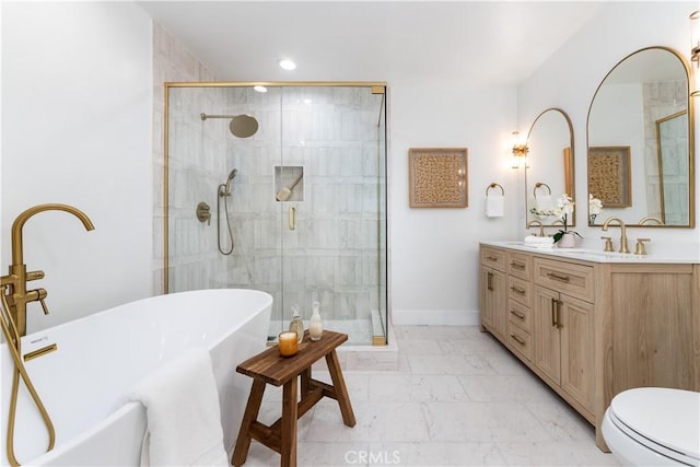 bathroom with vanity and shower with separate bathtub